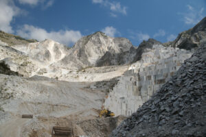 Quarries panorama. Carrara Marble. Panorama of a white Carrara marble quarry in Tuscany. Mountains of the Apuan Alps, blue sky and cloud. - MyVideoimage.com | Foto stock & Video footage