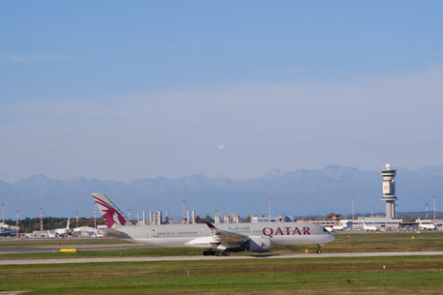 Quatar Airbus A350-941 airplane taxiing on the Malpensa airport runway. In the background the control tower. - MyVideoimage.com