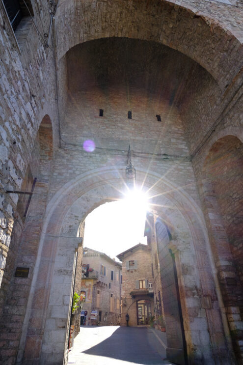 Ray of sun enters from the ancient San Pietro gate in Assisi. Made with mixed brick and stone masonry. - MyVideoimage.com