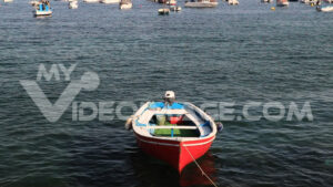 Red boat. Red-colored boat anchored at the sea port. Video footage.