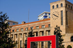 Red doors in La Spezia. Tower with clock and red doors in the square. Stock photos. - MyVideoimage.com | Foto stock & Video footage