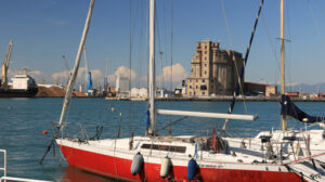 Sailboats anchored to the dock of the port. Abandoned warehouses - MyVideoimage.com