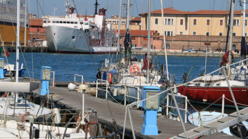 Sailboats anchored to the dock of the port. In the background a - MyVideoimage.com