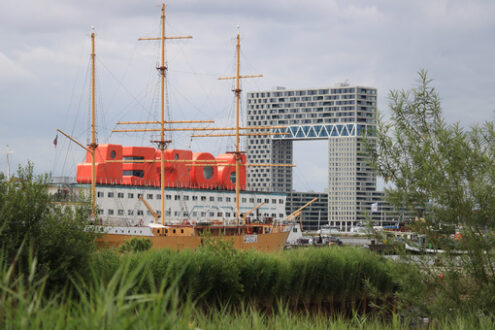 Sailing ship in the port of Amsterdam. In the background the boa - MyVideoimage.com