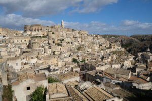 Sassi Matera. Panorama of houses and of the Sassi of Matera with roofs and streets. Blue sky with - MyVideoimage.com | Foto stock & Video footage