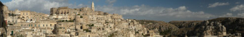 Sassi di Matera: Foto panoramica. Panoramic photography of the houses and the Sassi of Matera with the roofs and the streets. Blue sky with - MyVideoimage.com | Foto stock & Video footage