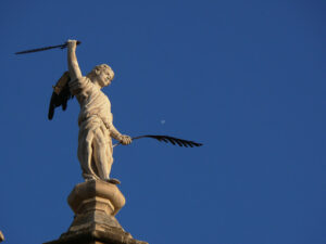 Sculpture of angel with pen and sword. - MyVideoimage.com