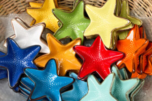 Sea stars. Corniglia, Cinque Terre. Handmade ceramic decorations representing colored sea stars - MyVideoimage.com | Foto stock & Video footage