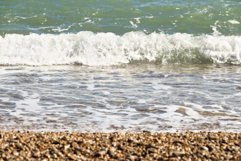 Sea waves break on the beach with stones. - MyVideoimage.com