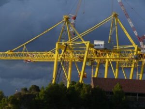 Shipyard in La Spezia. Large yellow crane in a shipyard. Cloudy sky background. - MyVideoimage.com | Foto stock & Video footage