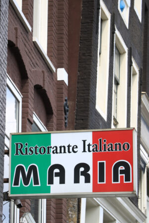 Sign of the Italian restaurant Maria with the green, white and red Italian flag. - MyVideoimage.com