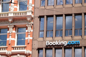 Signboard of Booking.com on the facade of a building. - MyVideoimage.com