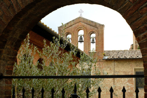 Small bell tower with three bells. Glimpse of the city of Siena in Tuscany. Brick brick building.  Stock photos. Siena, Tuscany, Italy. - MyVideoimage.com | Foto stock & Video footage