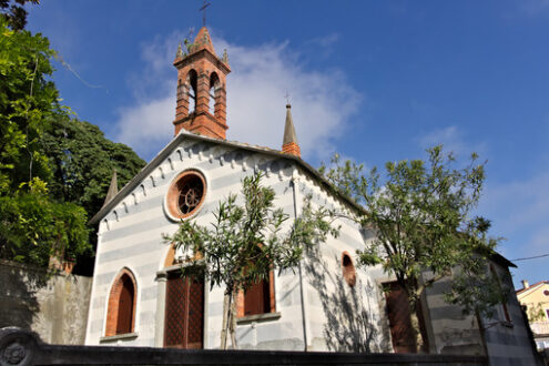 Small church. Liguria. Small church in the village of Framura, near the Cinque Terre. Genoese neo-Gothic style of a small church. - MyVideoimage.com | Foto stock & Video footage