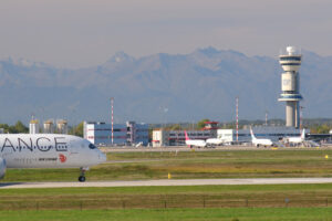 Star Alliance Lufthansa Airbus A319-100 on the Malpensa airport runway. In the background the control tower. - MyVideoimage.com