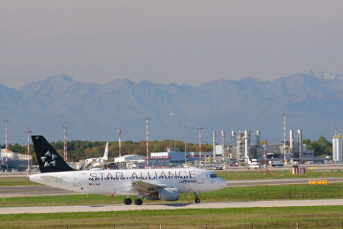 Star Alliance Lufthansa Airbus A319-100 on the Malpensa airport runway. In the background the mountains of the Alps. - MyVideoimage.com