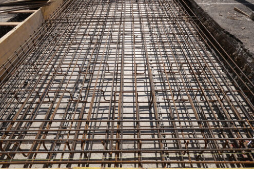 Steel rods. Dense texture of steel rods of a reinforced concrete foundation. Construction site. Cantieri edili. - MyVideoimage.com | Foto stock & Video footage