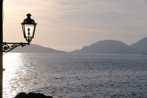 Street lamp on the sea. Sunset light on the sea of the Gulf of La Spezia. Tellaro, near the Cinque Terre. - MyVideoimage.com | Foto stock & Video footage