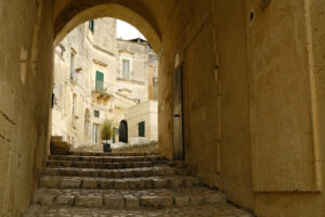 Street of the village. Matera. Road in the ancient city of Matera. Paving with beige stone and covering with arch and vault. - MyVideoimage.com | Foto stock & Video footage