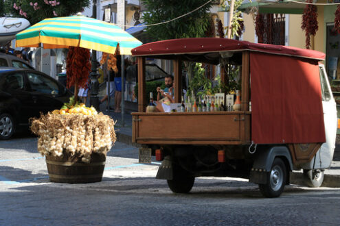 Street vendor selling typical products with Ape Car. Liqueurs, w - MyVideoimage.com