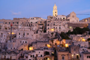 Sunset in Matera. Sunset lights in the city of Matera. Bell tower, church and typical houses called Sassi. - MyVideoimage.com | Foto stock & Video footage