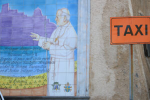 Taxi parking sign and mural on ceramic with the image of Pope Sa - MyVideoimage.com