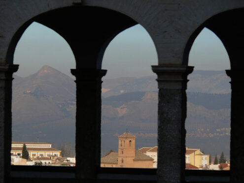 The city of Granada framed by the arches of a portico. Granada foto. Granada photo