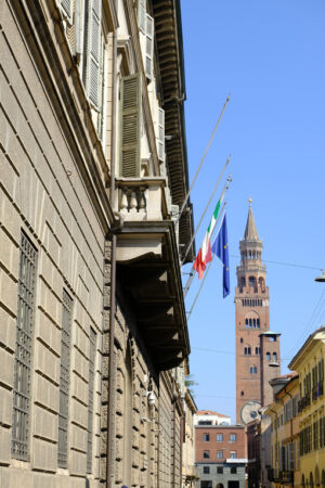 Torrazzo of Cremona and palace with flags. - MyVideoimage.com | Foto stock & Video footage