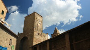 Tower with clock and bell tower in Castiglione della Pescaia. An ancient village in the Tuscan Maremma built on a hill facing the sea. - MyVideoimage.com