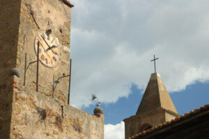 Tower with clock and bell tower in Castiglione della Pescaia. An ancient village in the Tuscan Maremma built on a hill facing the sea. - MyVideoimage.com