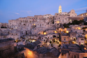 Tramonto a Matera. Sunset lights in the city of Matera. Bell tower, church and typical houses called Sassi. - MyVideoimage.com | Foto stock & Video footage