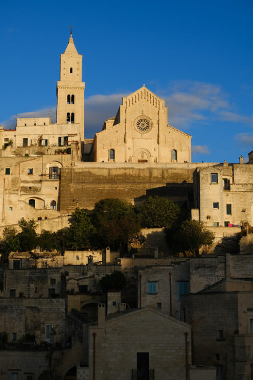 Tuff constructions in Matera. Houses, church and bell tower in the city of Matera in Italy. The tuff blocks are the material used for the construction of the houses. - MyVideoimage.com | Foto stock & Video footage