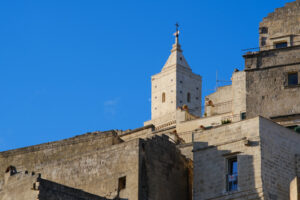 Tuff houses. Houses and bell tower in the city of Matera in Italy. The tuff blocks are the material used for the construction of the houses. - MyVideoimage.com | Foto stock & Video footage