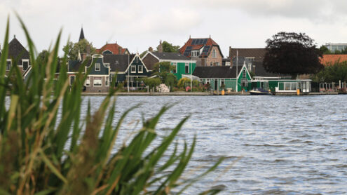 Typical Dutch houses. Typical Dutch houses on the canal near Amsterdam. In the land of windmills there are many traditional houses along the river. - MyVideoimage.com | Foto stock & Video footage