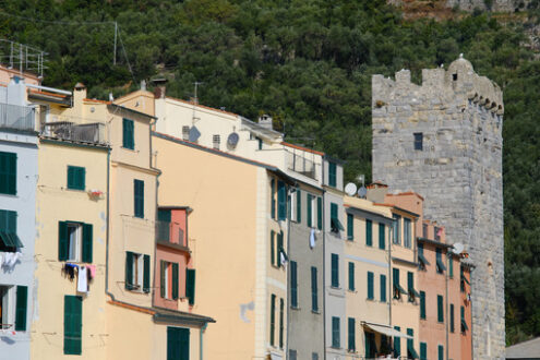 Typical Ligurian houses in the village of Portovenere. In the background a tower belonging to the walls of the fort. - MyVideoimage.com | Foto stock & Video footage