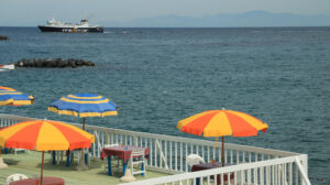 Umbrella on a pier with a white parapet on the sea of Ischia. In - MyVideoimage.com