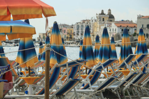 Umbrellas and deckchairs on the beach of Ischia Porto. Foto Ischia photos.