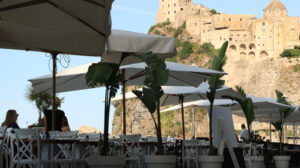 Umbrellas of a romantic seaside restaurant. In the background th - MyVideoimage.com