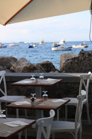 Umbrellas of a romantic seaside restaurant. In the background th - MyVideoimage.com