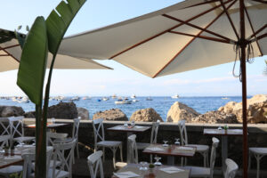 Umbrellas of a romantic seaside restaurant. In the background th - MyVideoimage.com