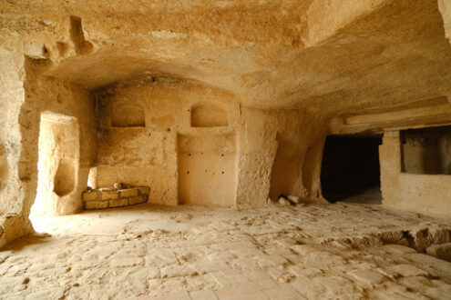 Underground house. Sassi of Matera with arched ceilings and vaults. Doors and windows in an ancient underground house dug out of the tufa rock. - MyVideoimage.com | Foto stock & Video footage