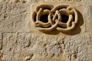 Ventilation grid. Ventilation grid on the front of a house. Made of stone with a decorative shape. Matera, Italy. - MyVideoimage.com | Foto stock & Video footage