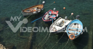 Video pescatore liguria. Fisherman with colorful rowboat in the blue sea of Liguria.  Video footage.