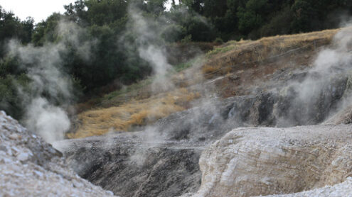 Volcanic fumaroles in the geothermal field. Jets of steam come out of the earth. Monterotondo, Larderello, Tuscany, Italy. - MyVideoimage.com