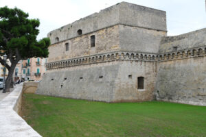 Walls of the Norman Swabian castle of Bari. The gardens with green plants and the fort built by Frederick II. Foto Bari photo.