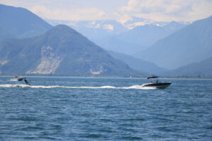 Water skiing on Lake Maggiore. A motorboat pulls a skier on the - MyVideoimage.com