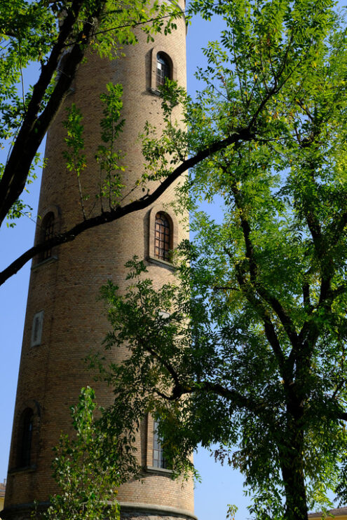 Water tower. Cylindrical brick tower soars into the blue sky. Stock photos. - MyVideoimage.com | Foto stock & Video footage