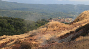 White rocks at the Biancane geothermal park. Steam jets and the town of Monterotondo Marittimo, near Larderello in Tuscany. - MyVideoimage.com