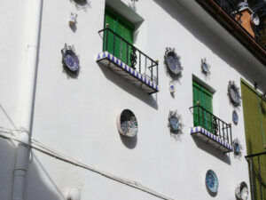 Window with sunblind curtain and facade with ceramic decorations - MyVideoimage.com