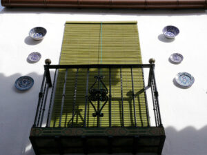 Window with sunblind curtain and facade with ceramic decorations - MyVideoimage.com